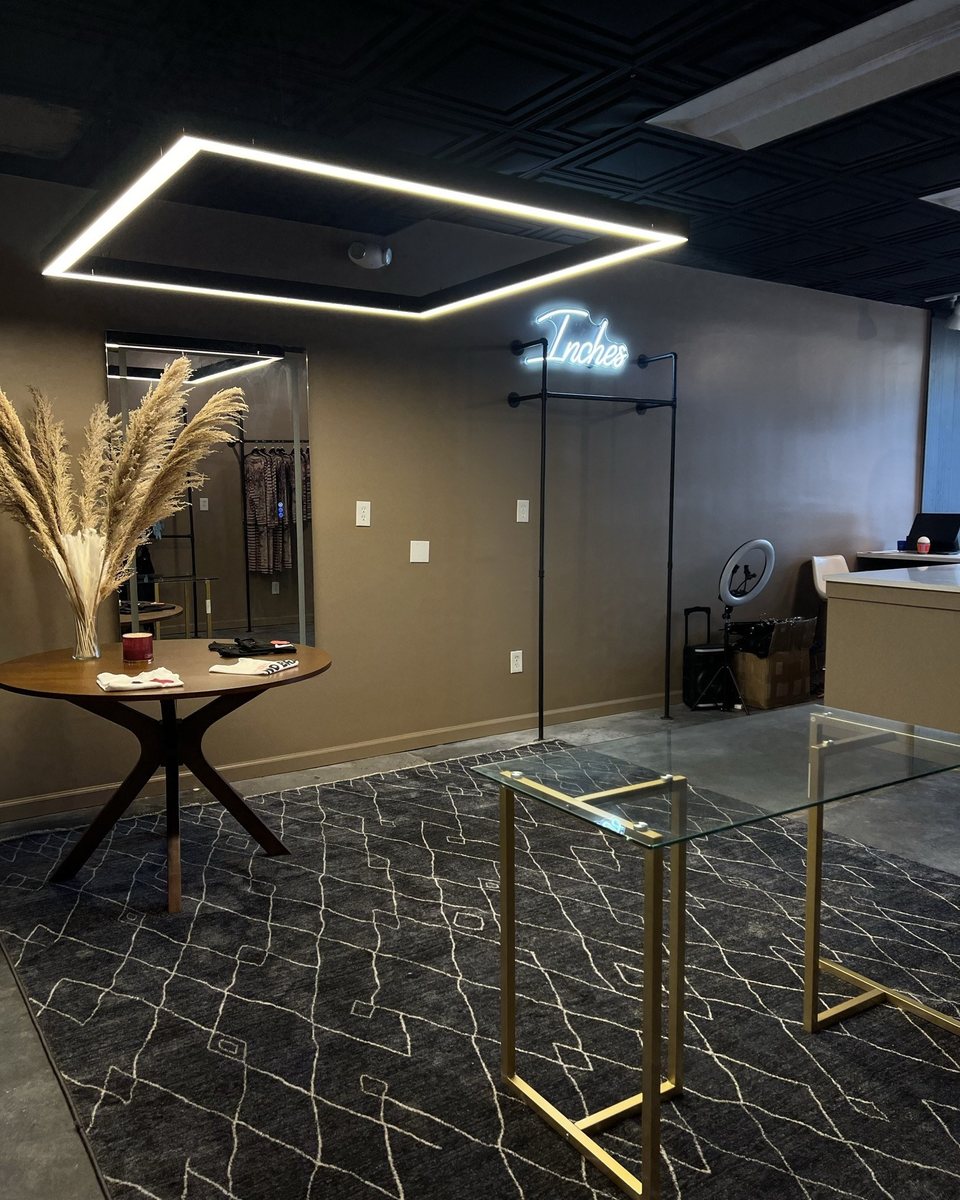 Finished Revamp entry with geometric ceiling light, marble surfaces, and dark architectural details