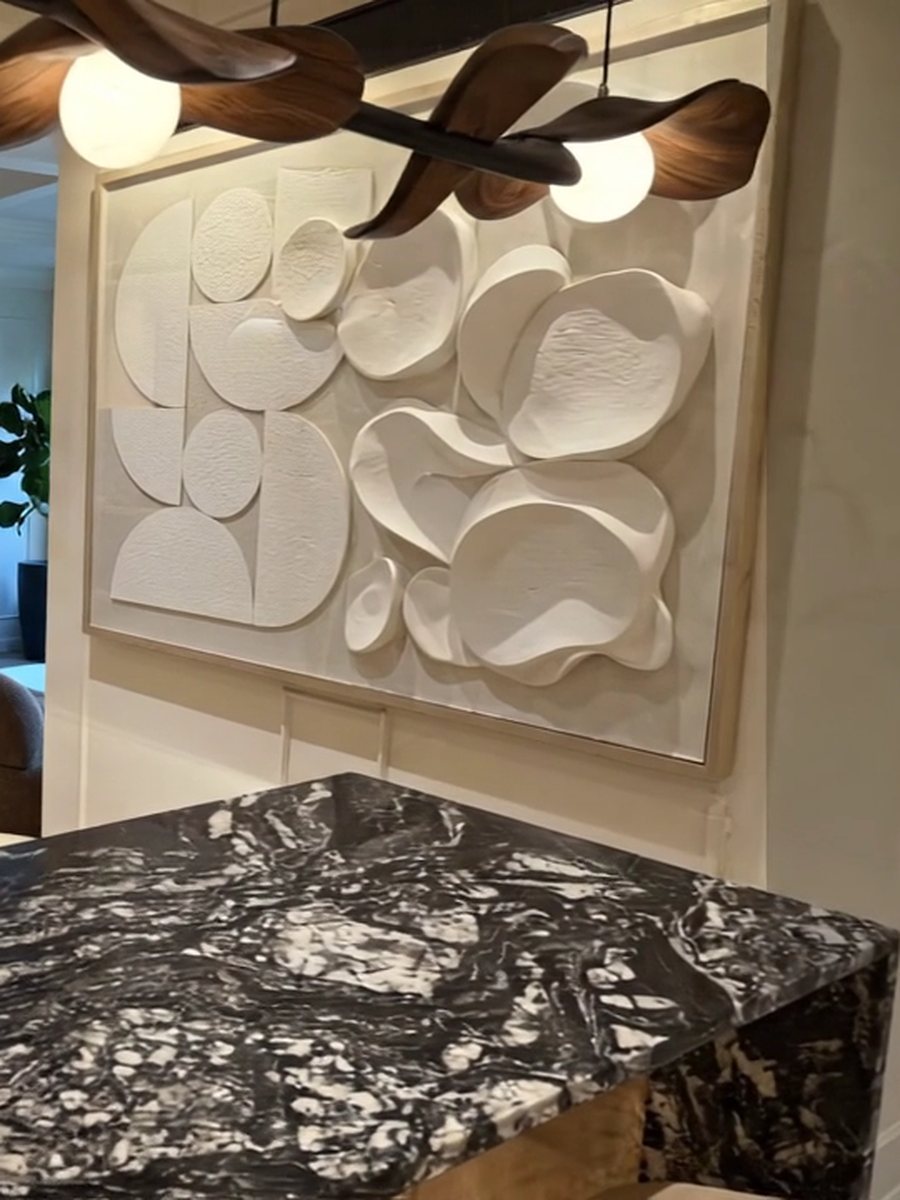 Residential interior with sculptural lighting and warm stone surfaces